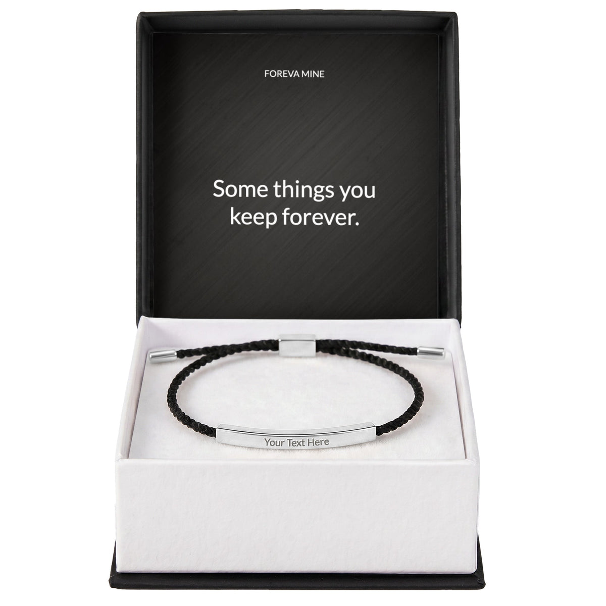 The standard gift box: a black box with a white tray holding the silver engraved cord bracelet, the Foreva Mine message card printed inside the lid