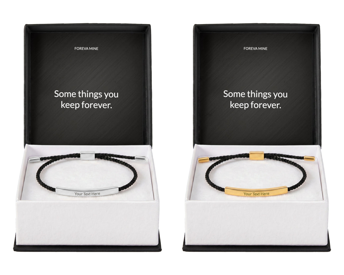 The engraved cord bracelet in two finishes side by side, polished silver on the left and 18k gold on the right, each in a gift box with a Foreva Mine message card