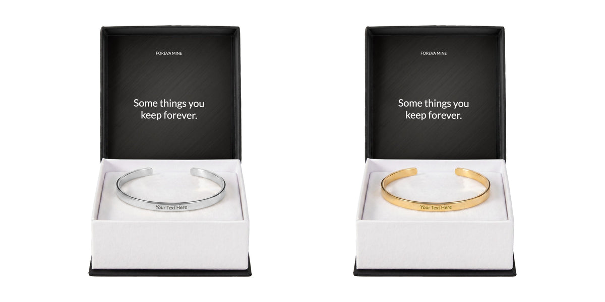 The engraved cuff bracelet in two finishes side by side, polished silver on the left and 18k gold on the right, each in a gift box with a Foreva Mine message card